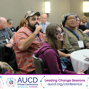Image of a conference participant holding a microphone speaking towards a conference room filled of participants. 
AUCD Virtual Conference Register Today Learning Together Connecting Research and Lived Experience 