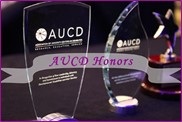 Title: AUCD Honors awards - Description: Photo of two glass awards on a black background. A text banner overlay says AUCD Honors.